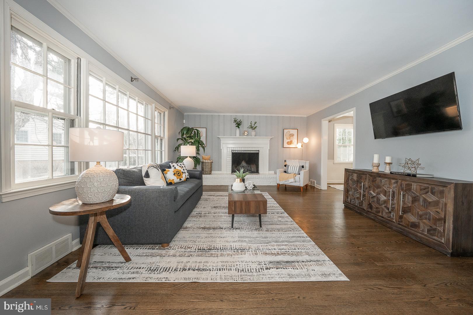 429 Conestoga Road Wayne, PA 19087 - Photo 2 of 33 a living room with furniture a flat screen tv and a fireplace