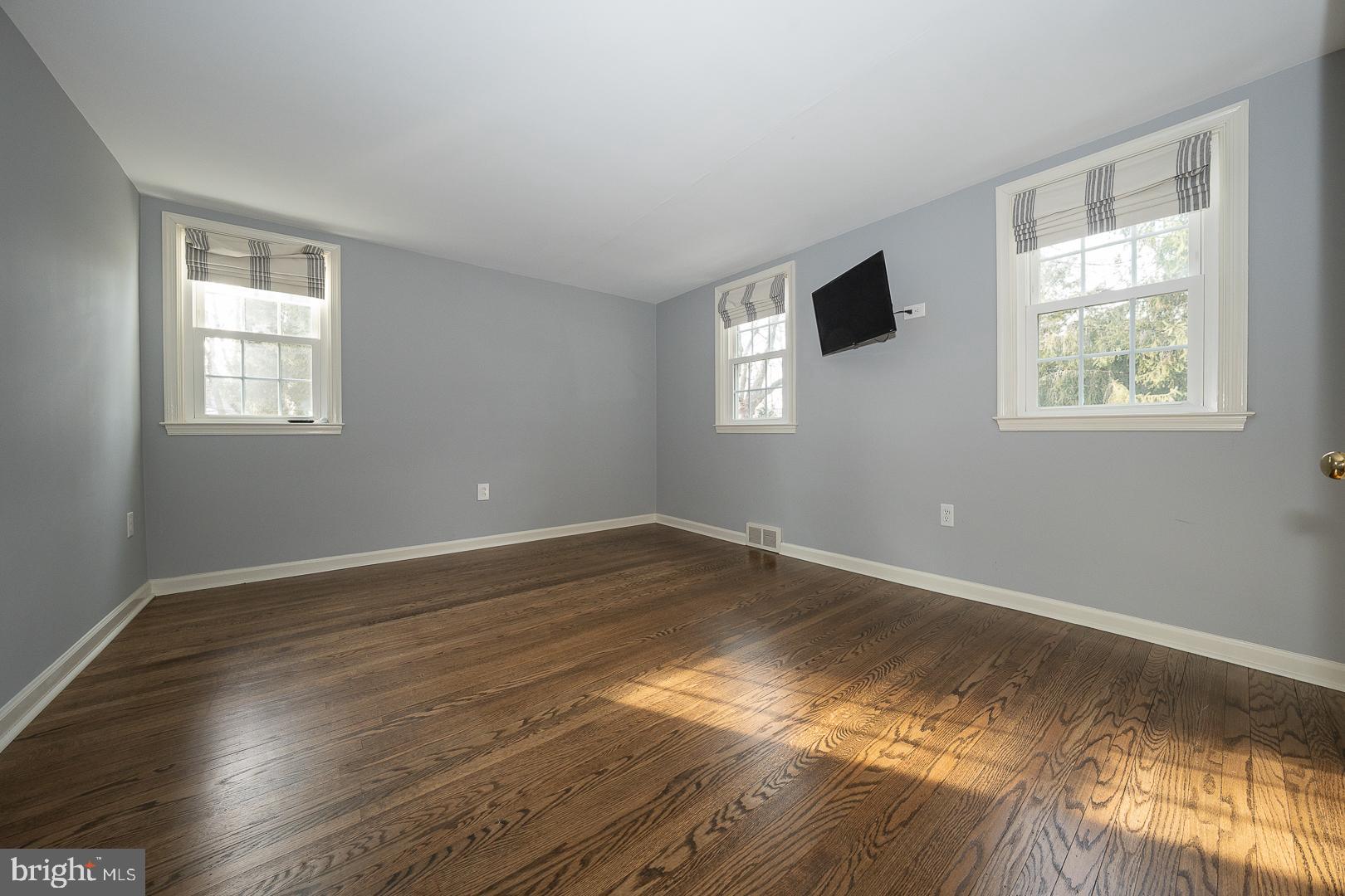 429 Conestoga Road Wayne, PA 19087 - Photo 21 of 33 a view of empty room with wooden floor and fan