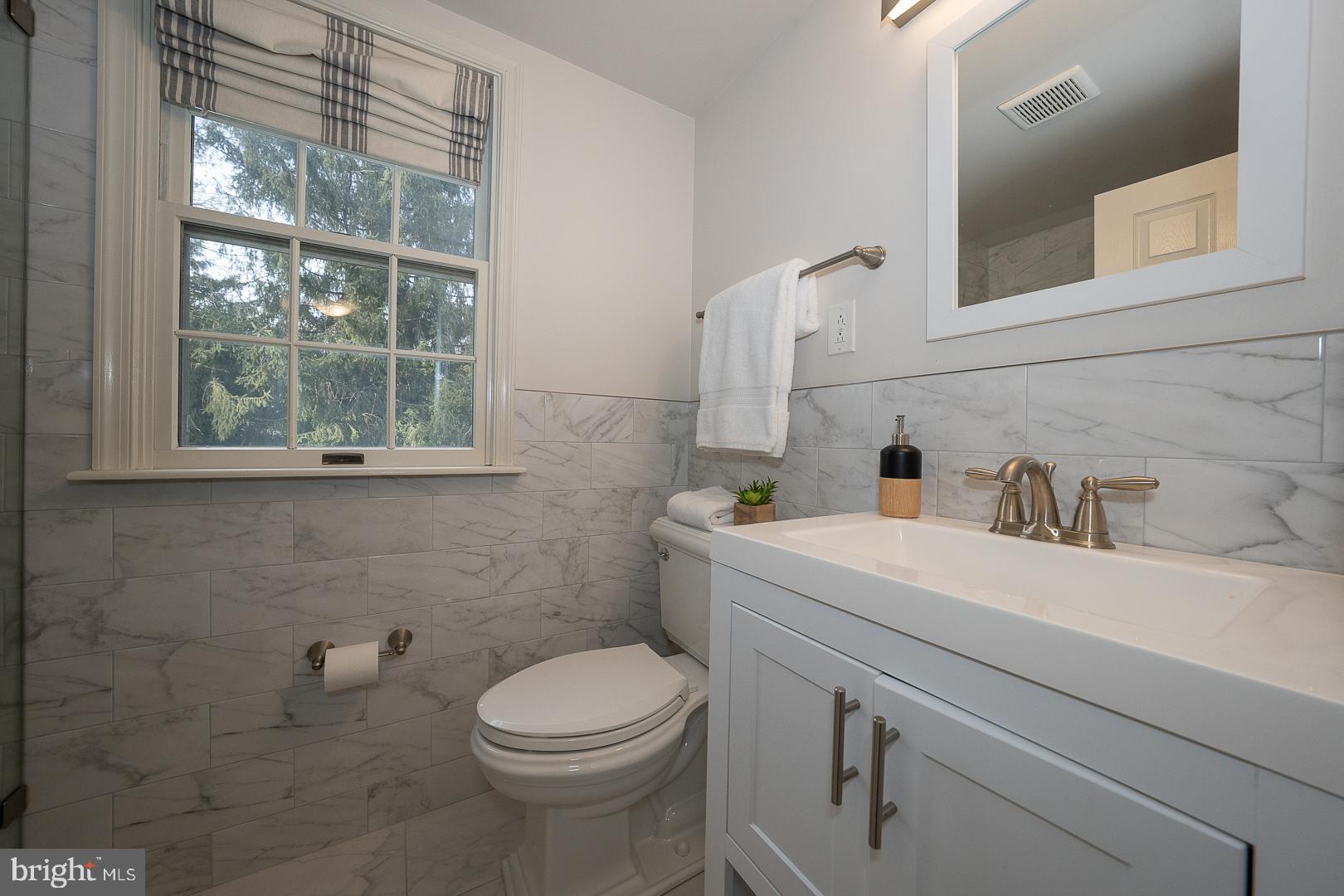 429 Conestoga Road Wayne, PA 19087 - Photo 22 of 33 a bathroom with a sink a toilet and a mirror