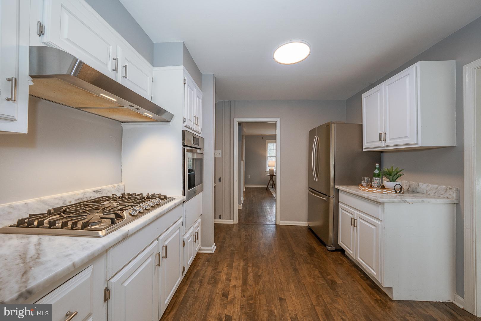 429 Conestoga Road Wayne, PA 19087 - Photo 10 of 33 a kitchen with stainless steel appliances granite countertop a stove and a refrigerator