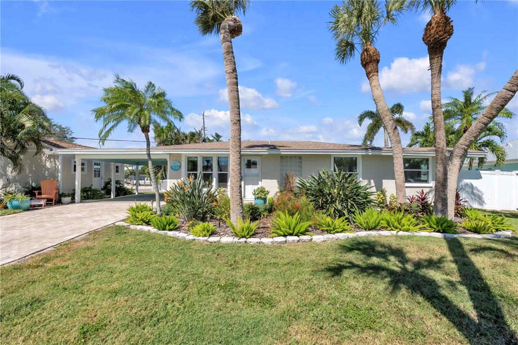 a front view of a house with a garden and a yard