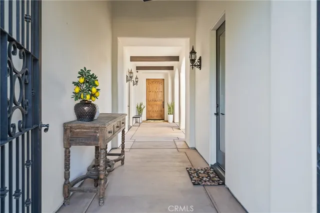 a view of a hallway with wooden floor and a dining room
