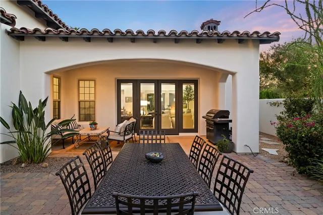 a view of a patio with table and chairs potted plants with wooden floor