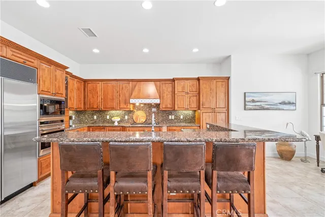 a kitchen with stainless steel appliances granite countertop counter top space and large windows