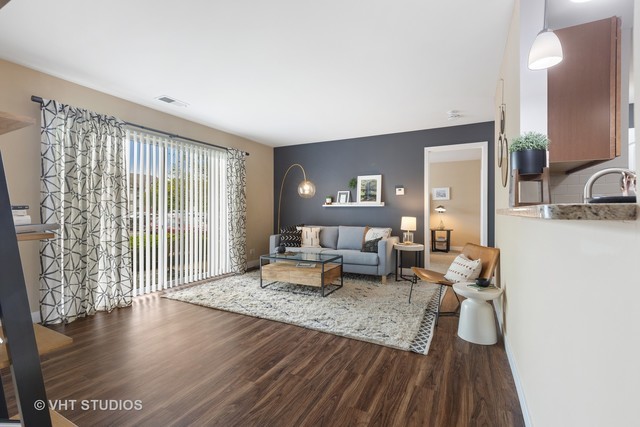 8 Sterling Circle, Unit 104 Wheaton, IL 60189 - Photo 9 of 36 a living room with furniture and a large window