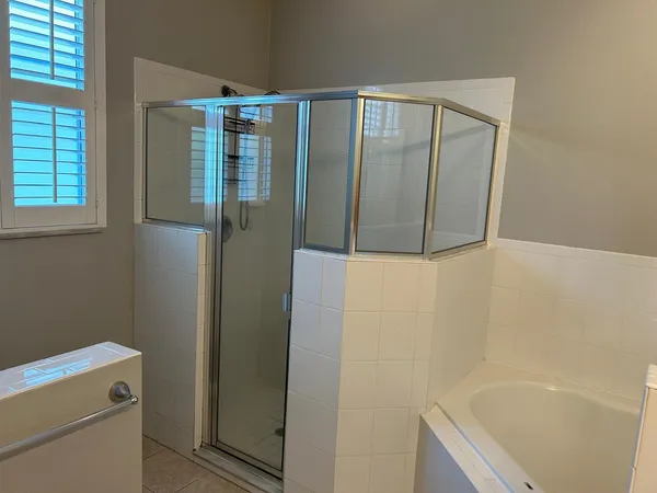 a bathroom with a bathtub and a shower