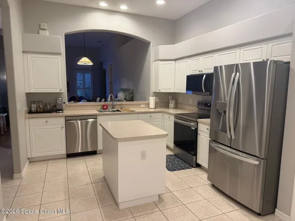 a kitchen with a stove sink and refrigerator