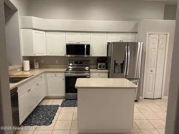 a kitchen with stainless steel appliances a stove refrigerator sink and microwave