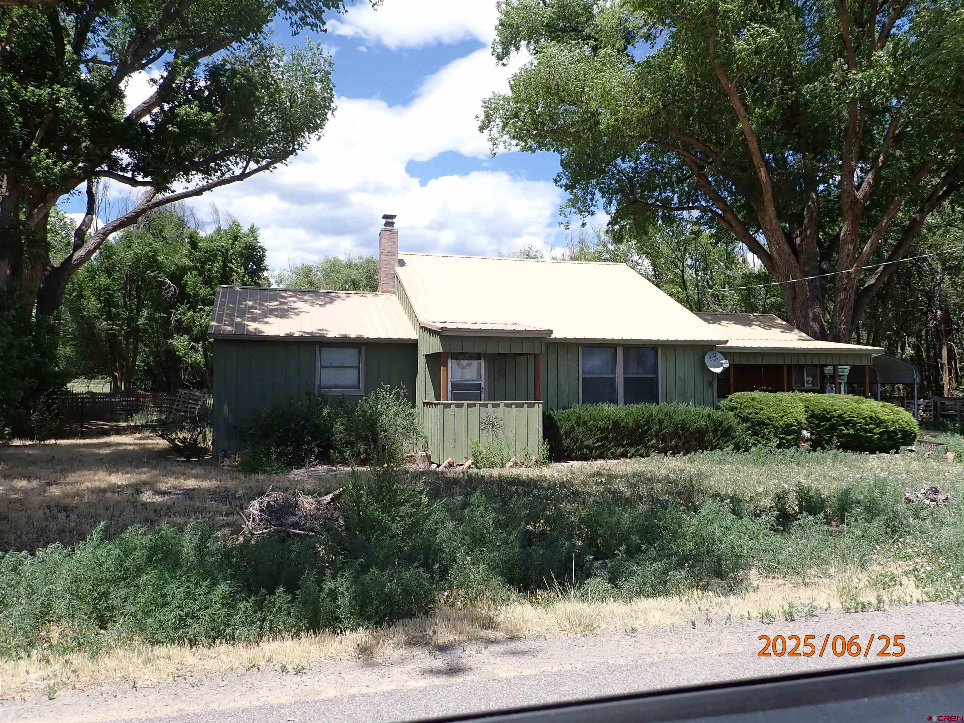 21391 Kaiser Road Austin, CO 81410 - Photo 1 of 12 a front view of house with yard and trees