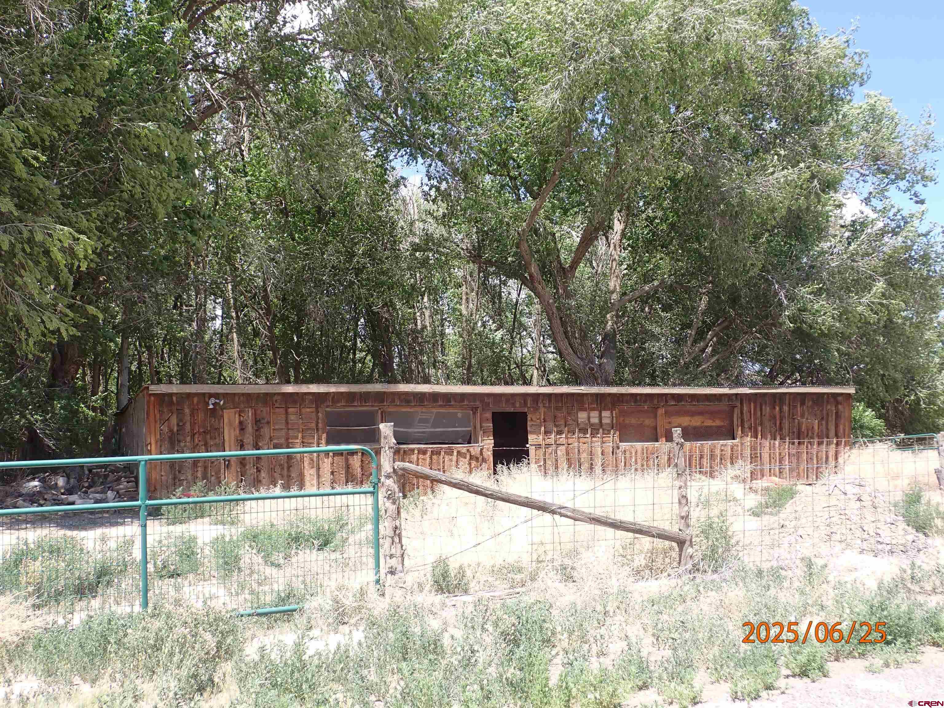 21391 Kaiser Road Austin, CO 81410 - Photo 12 of 12 a view of backyard with large trees and wooden fence