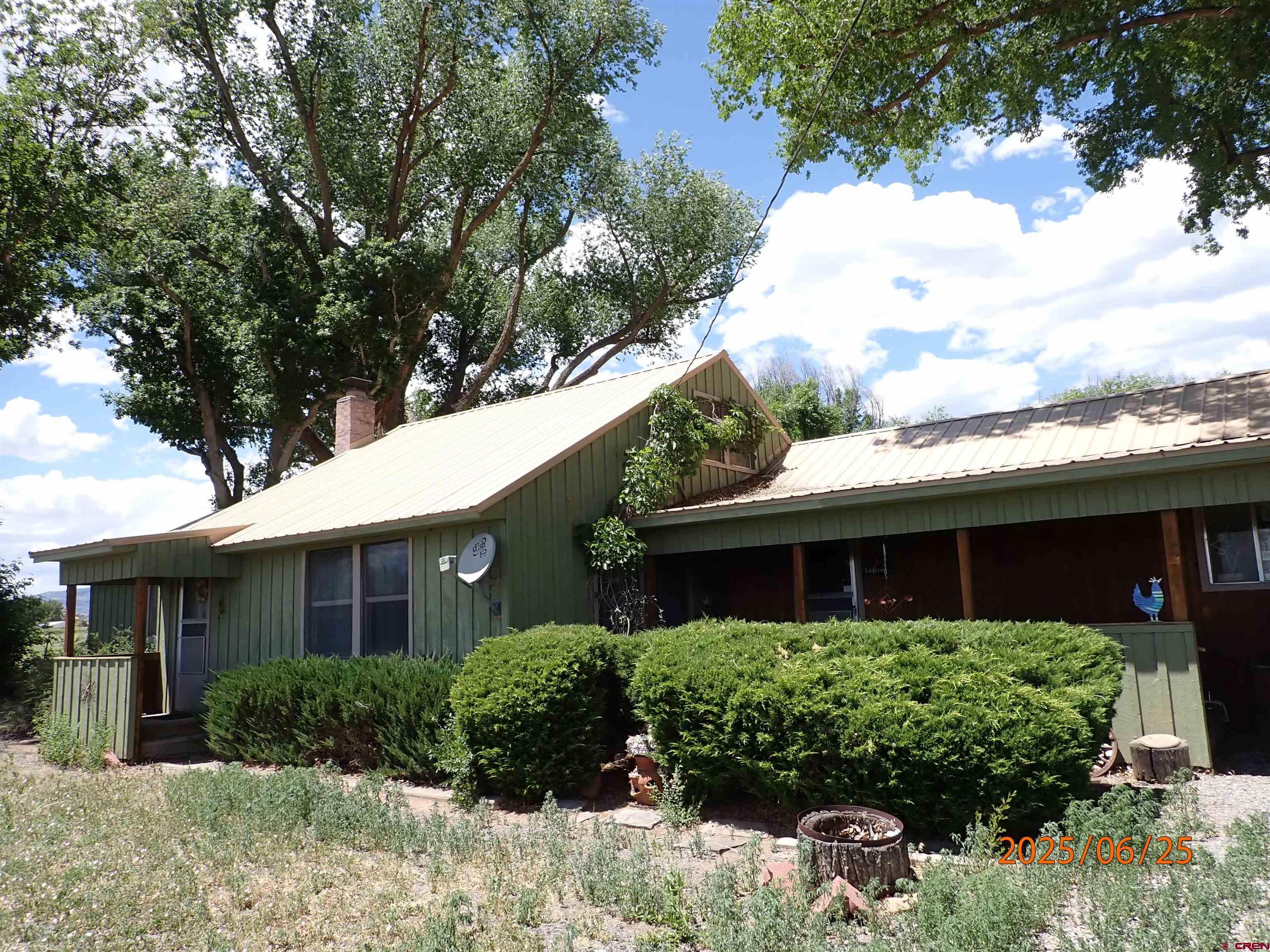 21391 Kaiser Road Austin, CO 81410 - Photo 2 of 12 a front view of a house with a yard