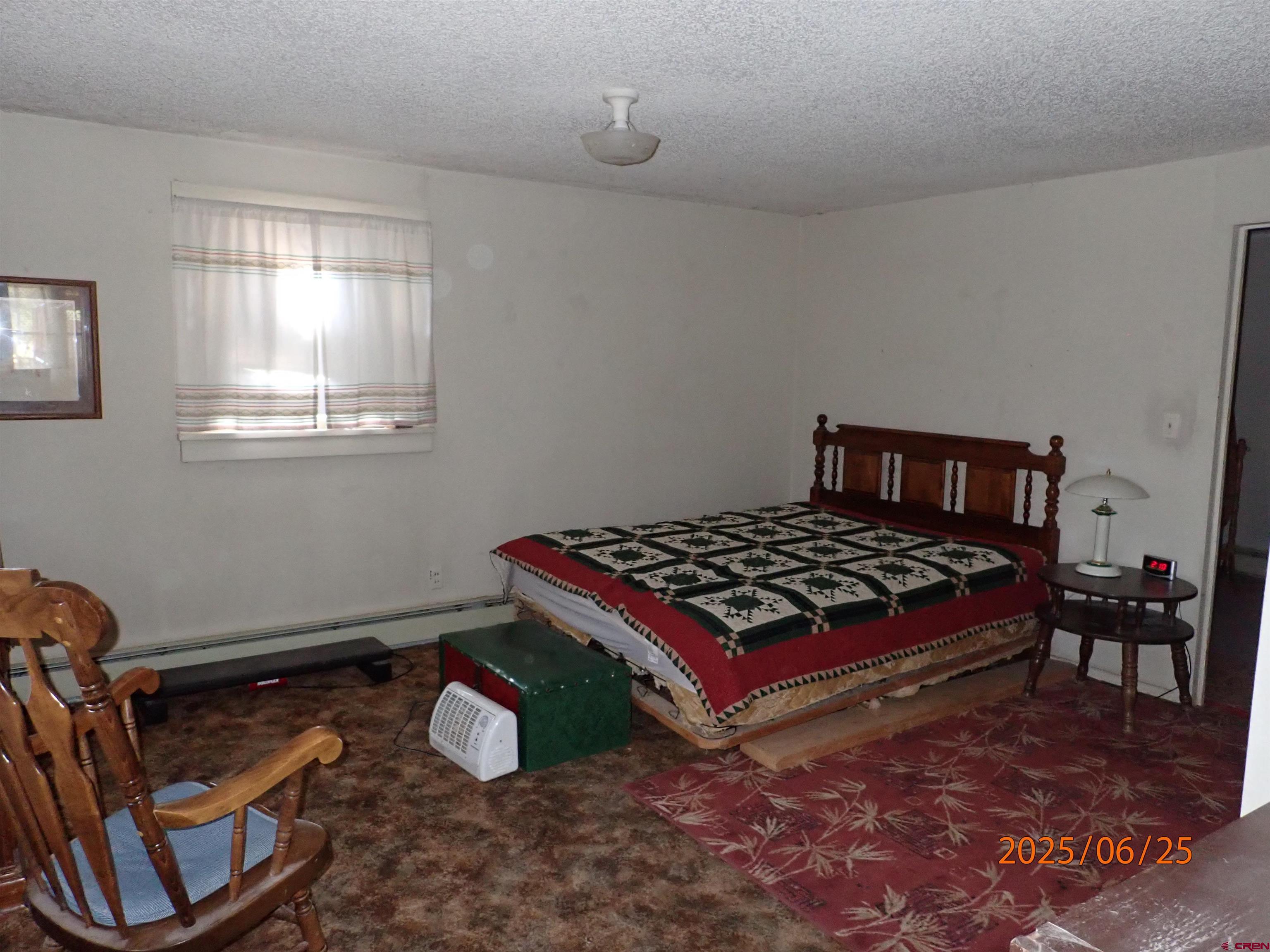 21391 Kaiser Road Austin, CO 81410 - Photo 7 of 12 a bedroom with a bed and window