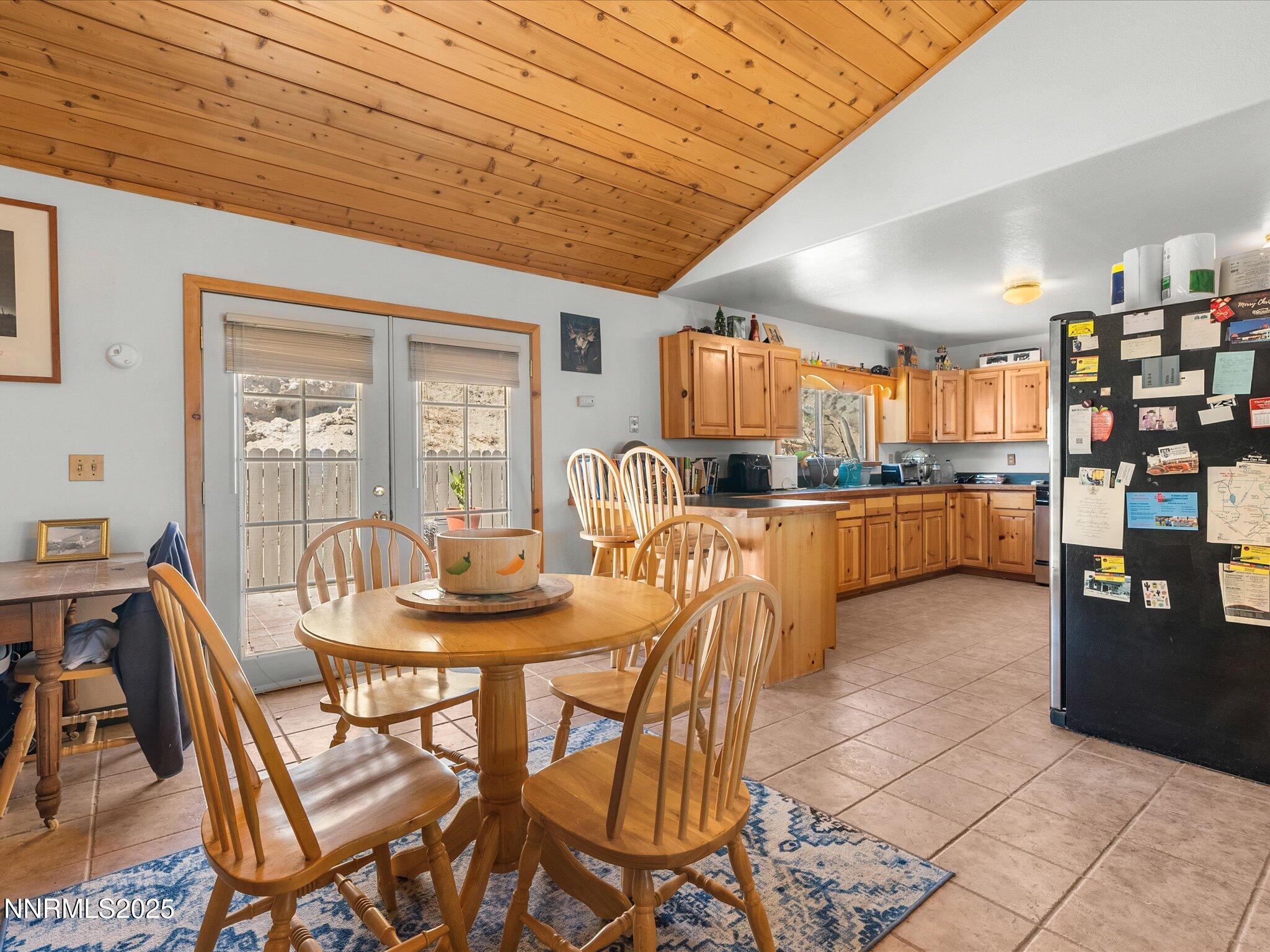 1 Cory Canyon Road Hawthorne, NV 89415 - Photo 16 of 77 a dining room with stainless steel appliances kitchen island granite countertop a table chairs and a refrigerator