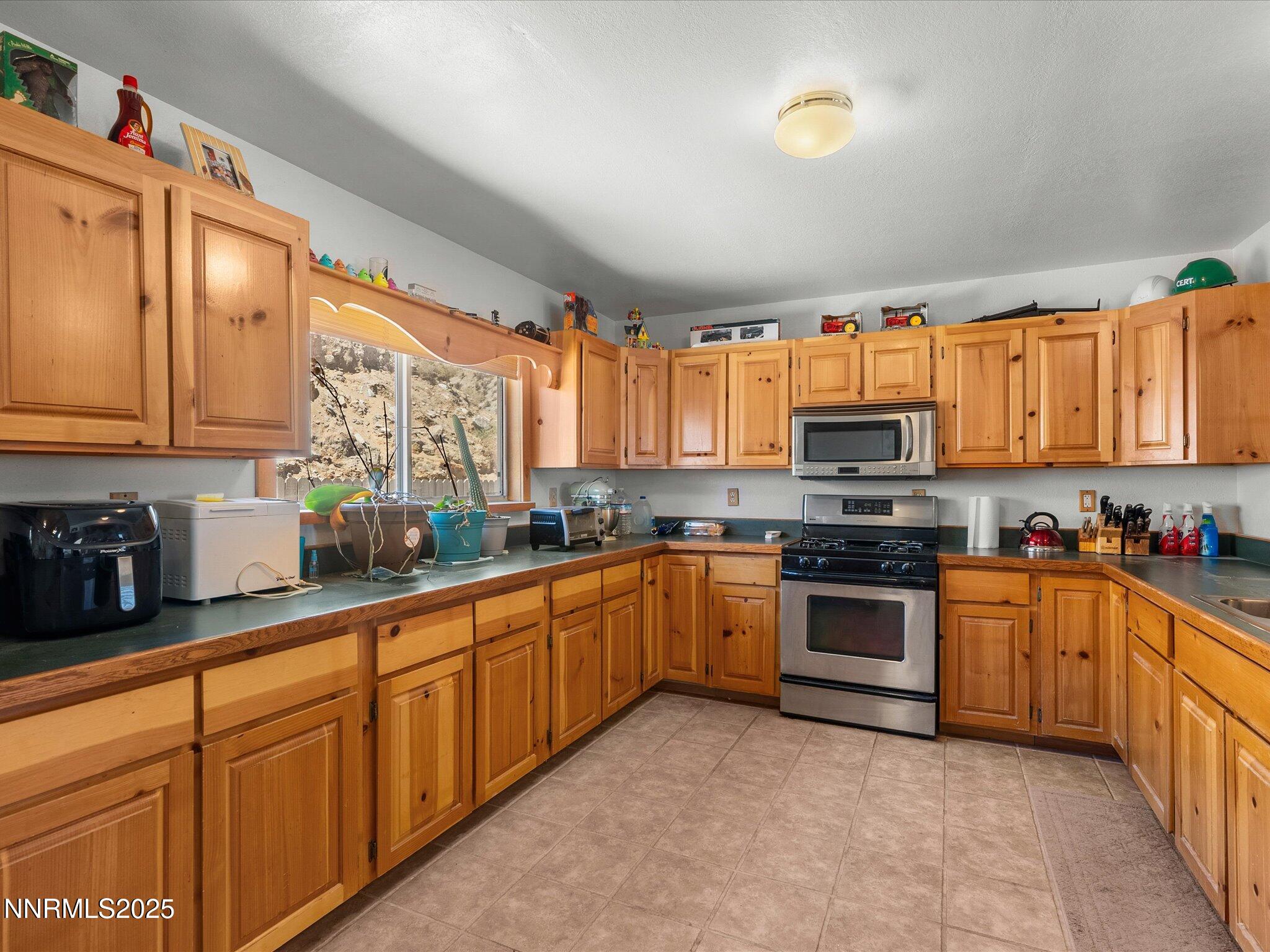 1 Cory Canyon Road Hawthorne, NV 89415 - Photo 21 of 77 a kitchen with stainless steel appliances granite countertop a stove sink and cabinets