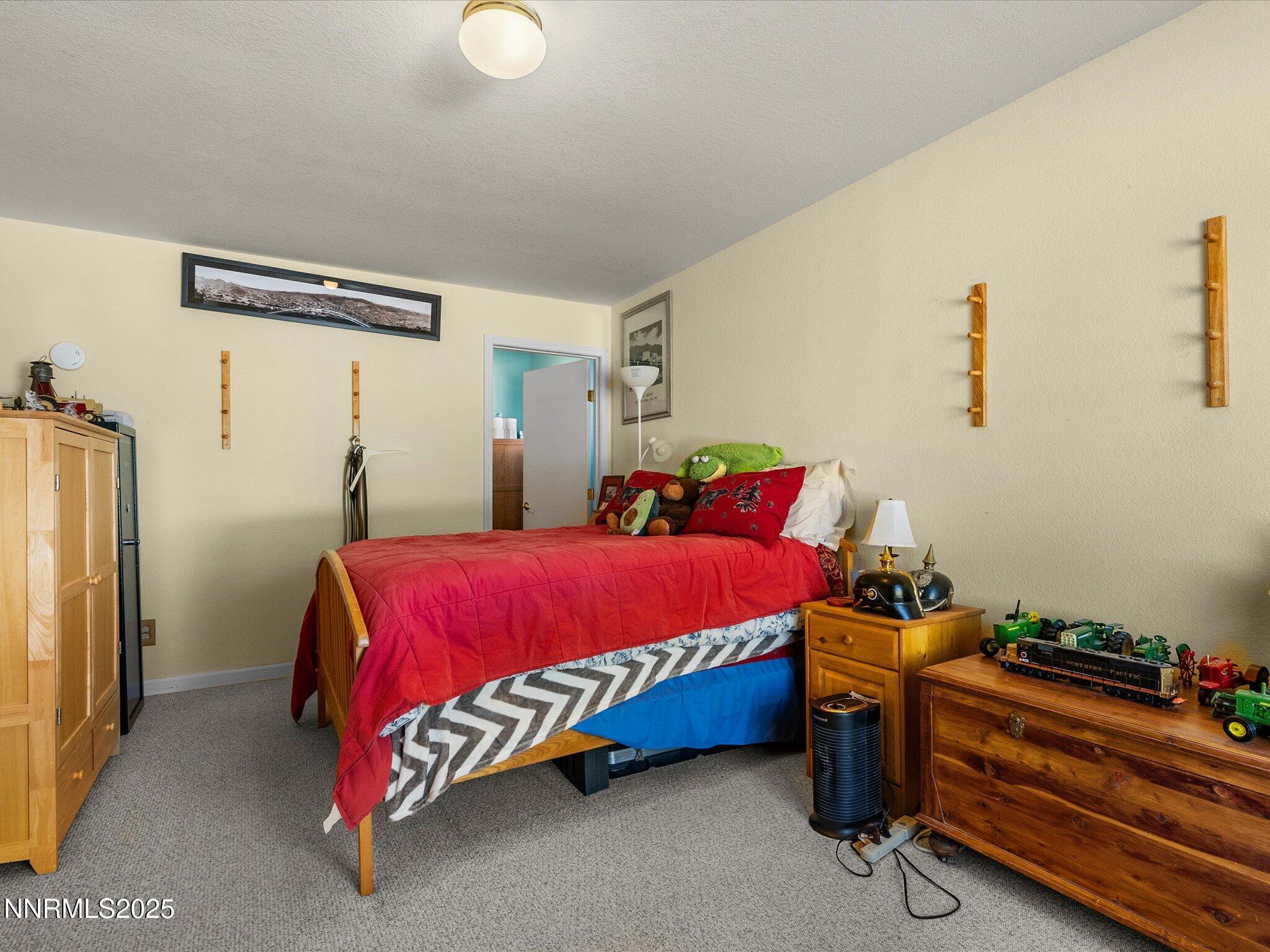 1 Cory Canyon Road Hawthorne, NV 89415 - Photo 22 of 77 a bedroom with a bed and a mirror