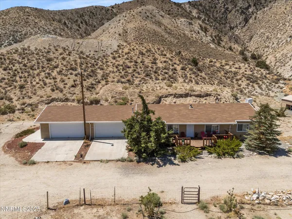a view of a dry yard with a mountain