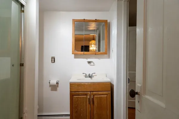 a view of a kitchen from a hallway