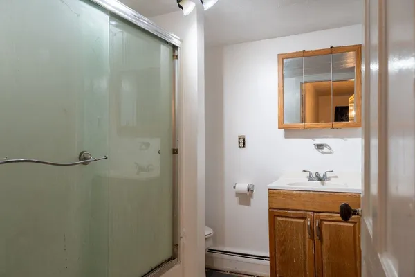 a kitchen with granite countertop white cabinets and a window
