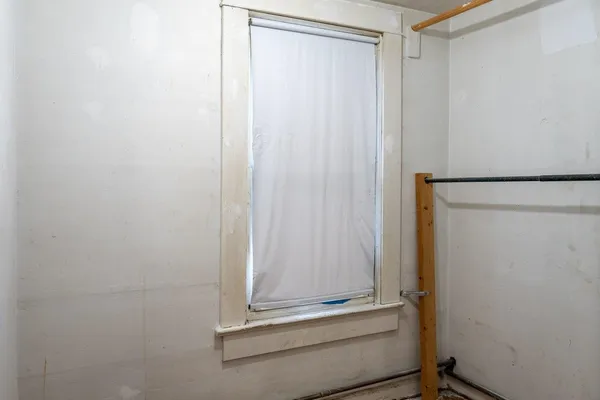 a view of a room with a tub and window