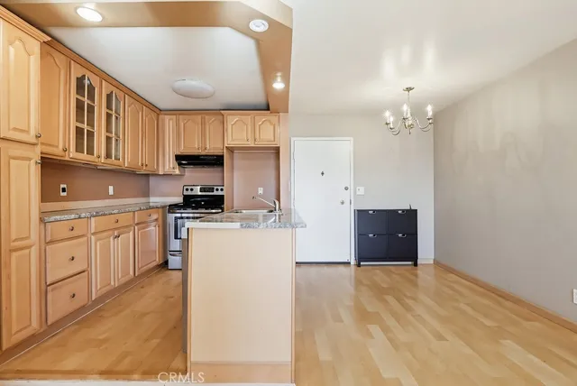 a open kitchen with cabinets a sink and appliances