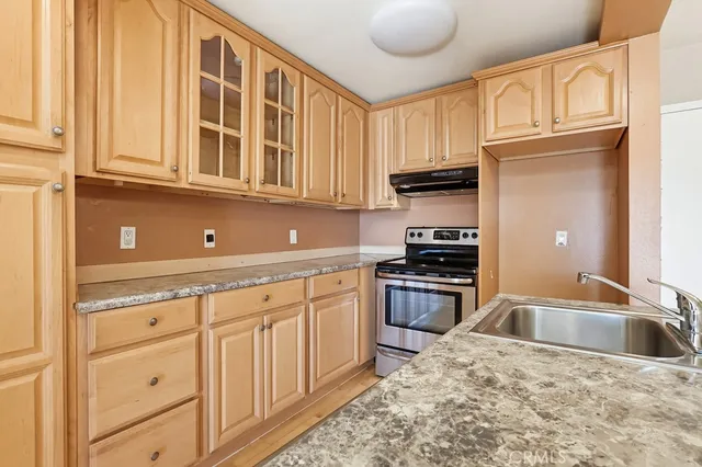 a kitchen with granite countertop a sink and cabinets