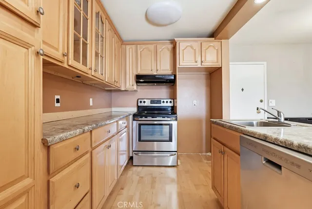 a kitchen with granite countertop a stove and a sink