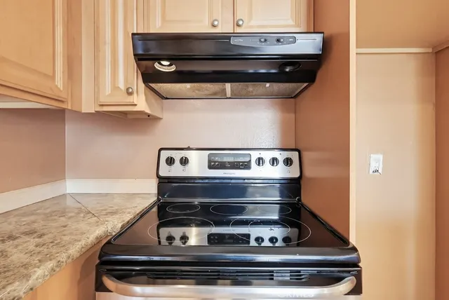 a stove top oven sitting inside of a kitchen