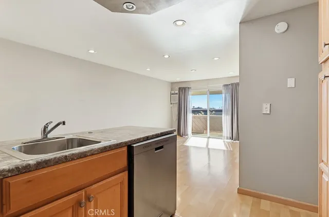 a kitchen that has a sink and a wooden floor