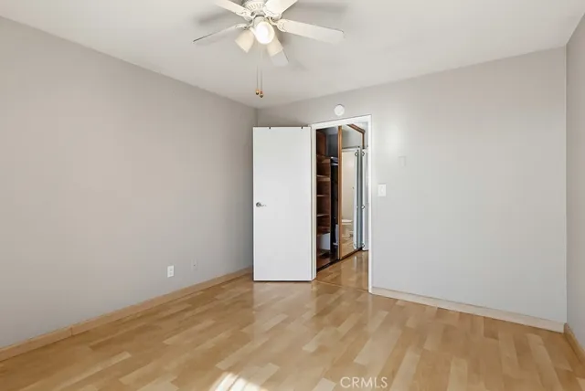 an empty room with a empty space and a ceiling fan