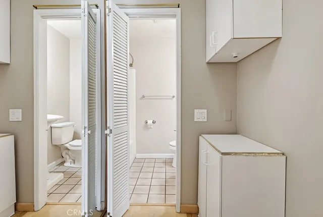 a white toilet sitting next to a bathroom sink