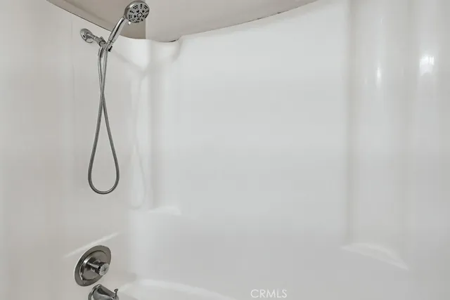 a white toilet sitting next to a bath tub