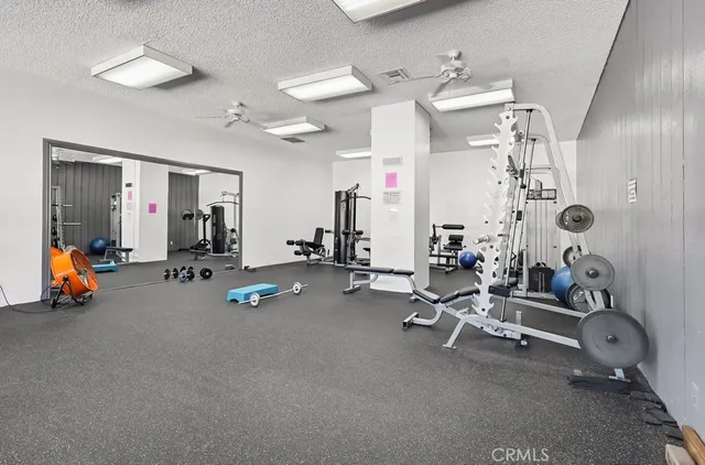 a view of a patio with a table and chairs and potted plants