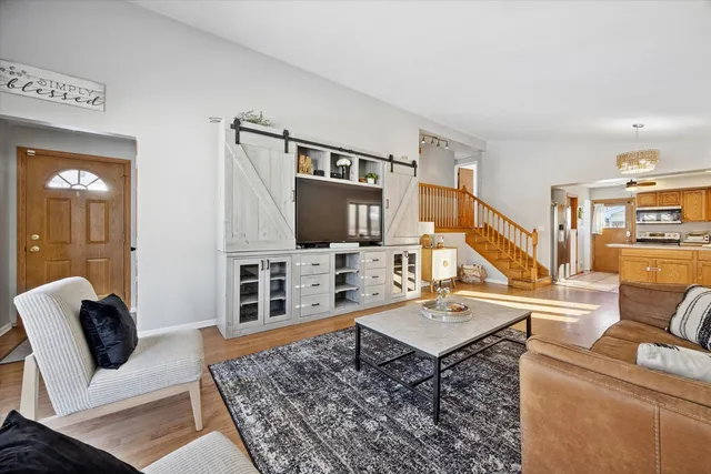a living room with furniture windows and a flat screen tv
