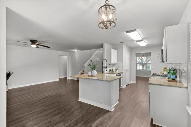 an empty room with window and a ceiling fan