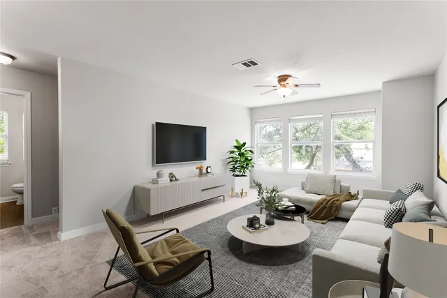 a kitchen with stainless steel appliances granite countertop a stove top oven a sink dishwasher and white cabinets with wooden floor