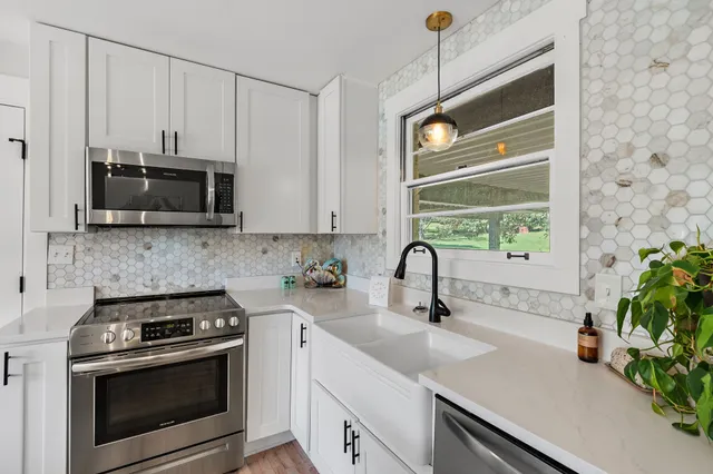 a kitchen with appliances a sink and a counter top space