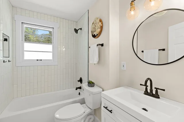 a bathroom with a sink a toilet and a mirror