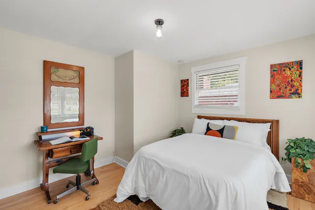 a bedroom with a bed and a window