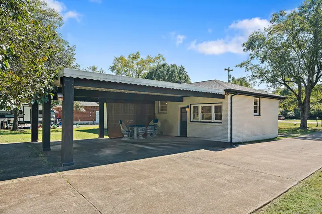 a front view of house with yard outdoor seating and barbeque oven