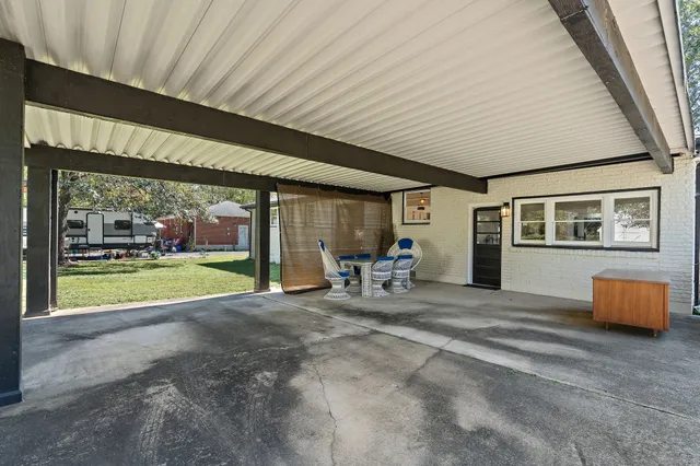 a view of a porch with furniture and garden