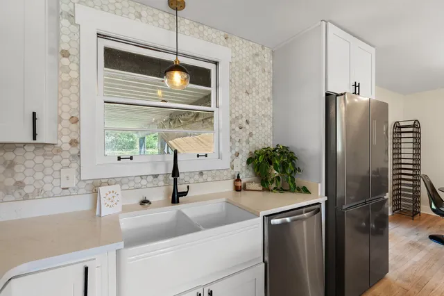 a kitchen with a sink and refrigerator