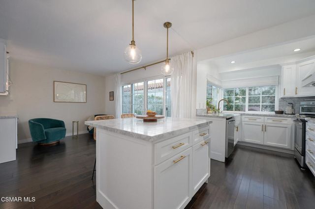 a kitchen with sink stove and wooden floor
