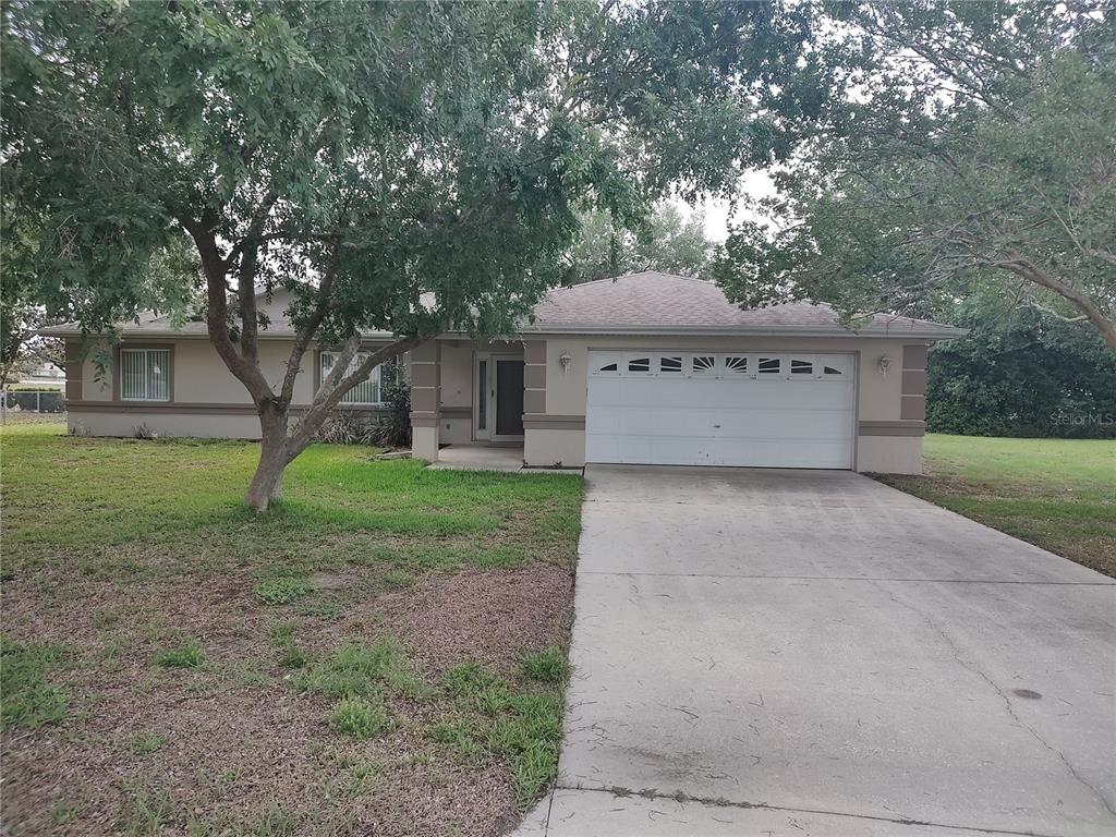 6202 Southwest 100th Loop Ocala, FL 34476 - Photo 1 of 24 a view of a house with yard and a tree