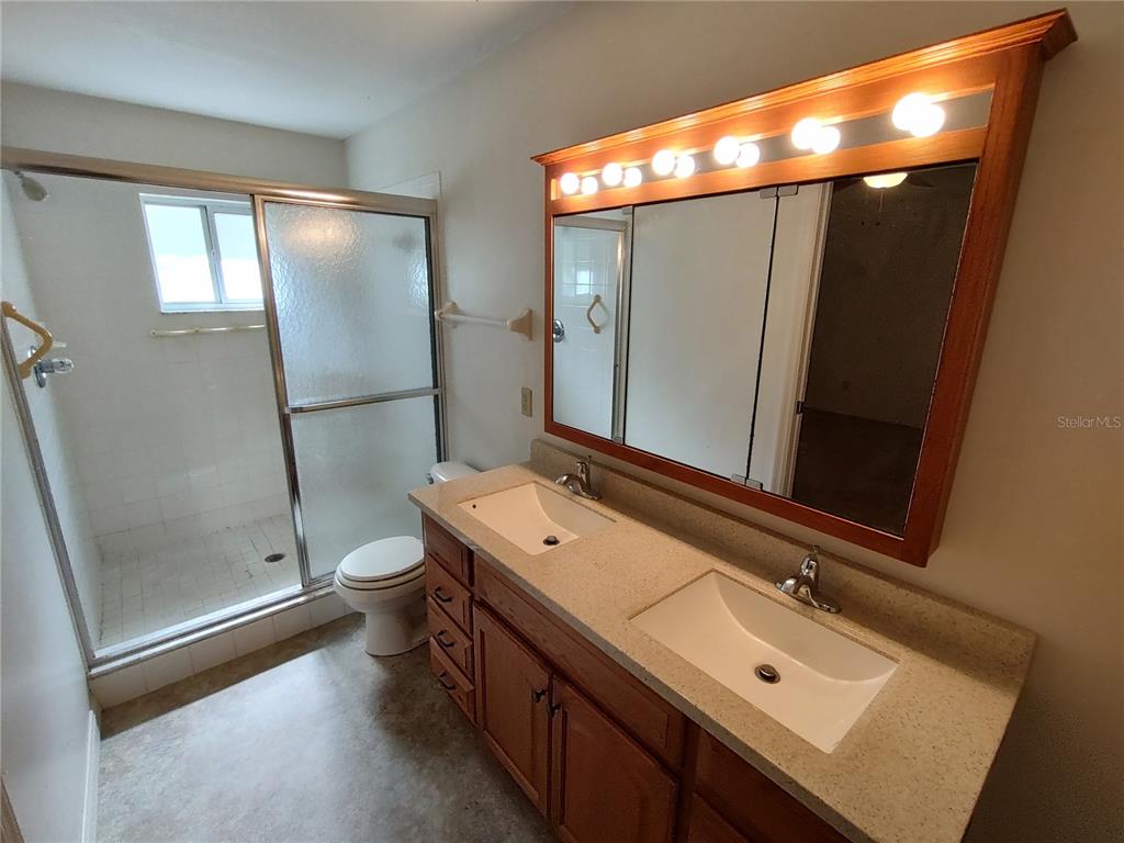 6202 Southwest 100th Loop Ocala, FL 34476 - Photo 17 of 24 a bathroom with a sink mirror and shower