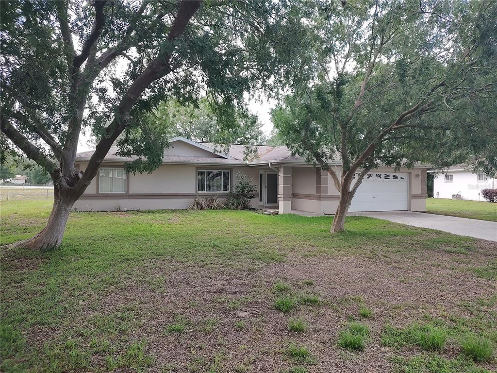 6202 Southwest 100th Loop Ocala, FL 34476 - Photo 2 of 24 a view of a house with yard and tree s