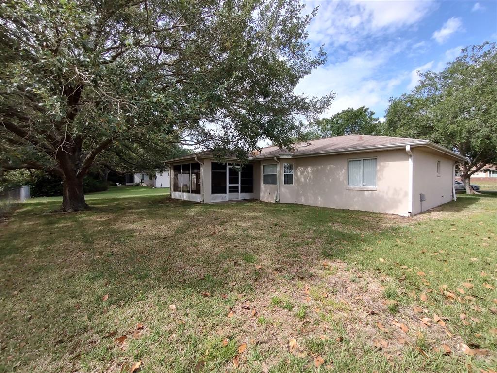 6202 Southwest 100th Loop Ocala, FL 34476 - Photo 21 of 24 a front view of house with yard and trees