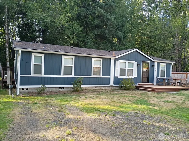 a view of a house with a yard and sitting area