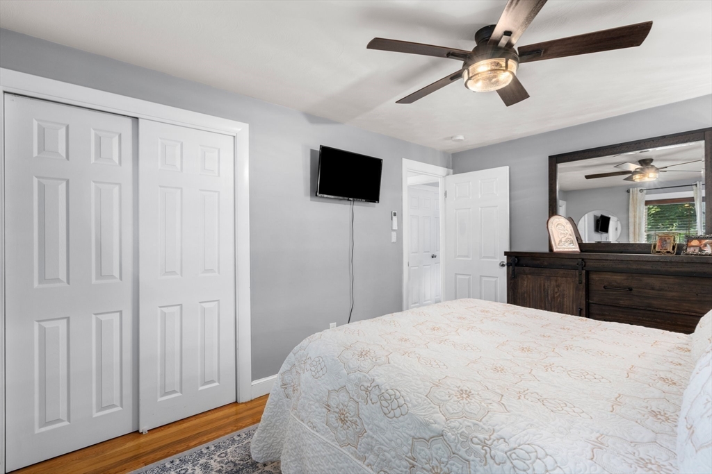 5 Albert Road Peabody, MA 01960 - Photo 14 of 39 a large bedroom with a bed and a chandelier