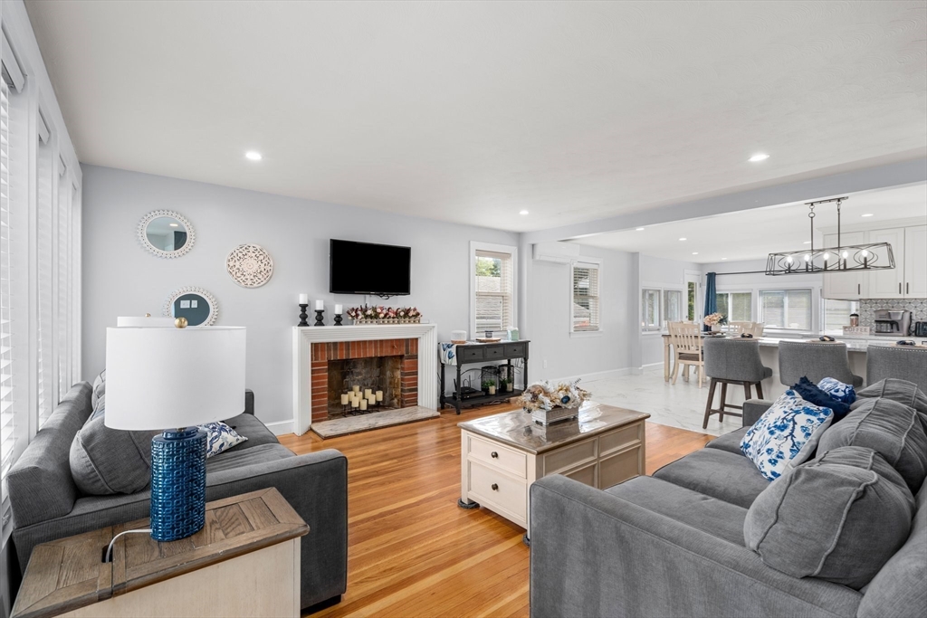 5 Albert Road Peabody, MA 01960 - Photo 2 of 39 a living room with furniture a fireplace and a flat screen tv
