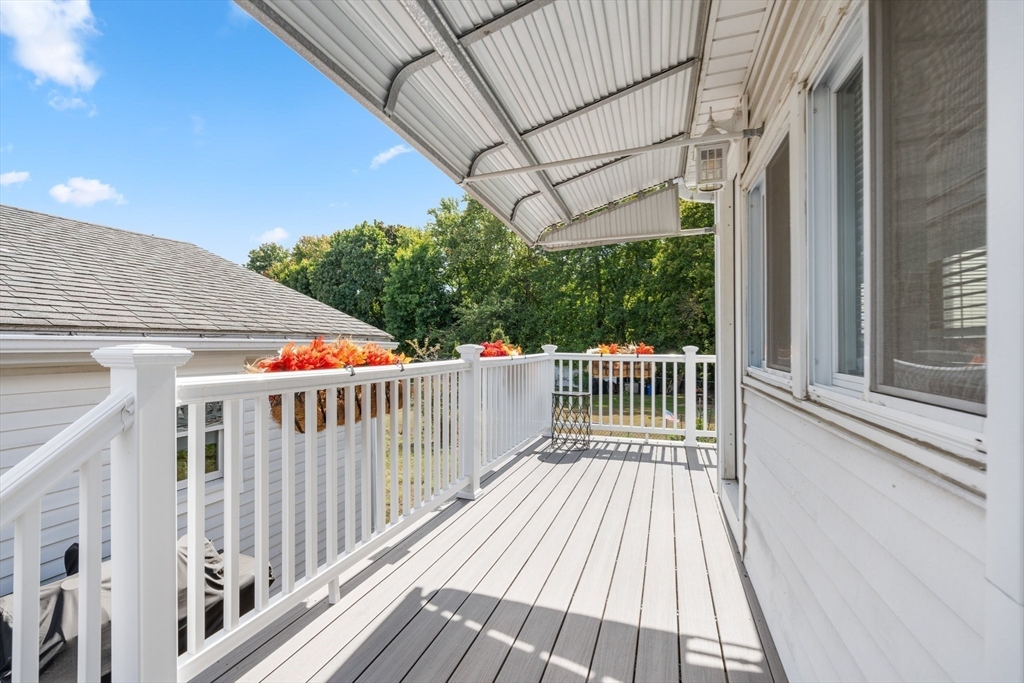 5 Albert Road Peabody, MA 01960 - Photo 28 of 39 a balcony with wooden floor in front of a house